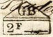 Marque rectangulaire surmontée d'un triangle avec lettres GB et 2F suivi d'un trait /